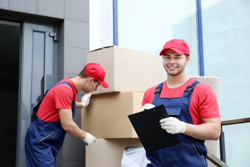 Professional team handling a piano removal in a Kensington property