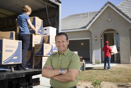 Careful loading of large household furniture for transport in Kensington