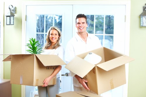 Professional movers handling furniture in a Kensington townhouse or apartment