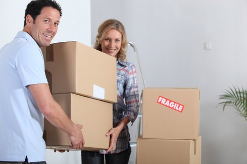 Trained movers handling items carefully with PPE in Kensington